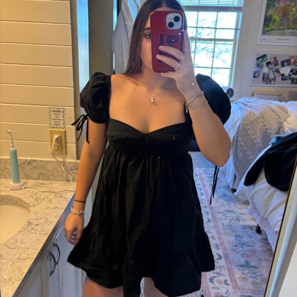 Olivaceous black mini dress with puffy sleeves and tie up straps. Size: S